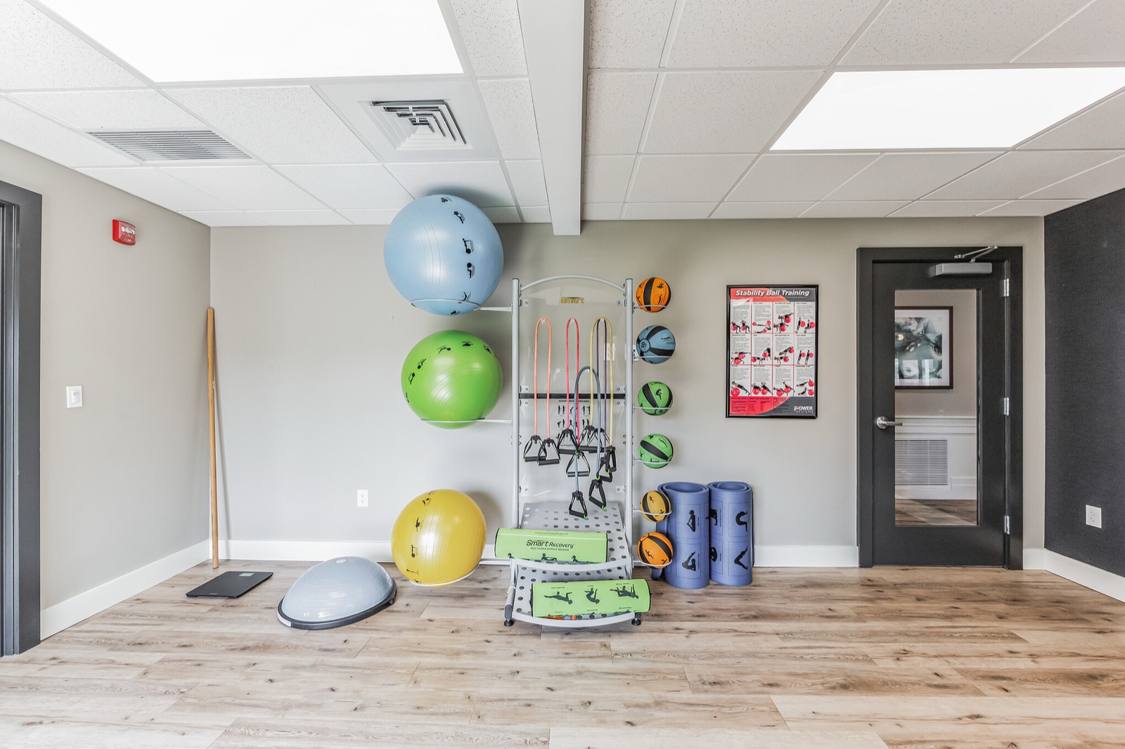 Wellness room wall with exercise balls and equipment storage
