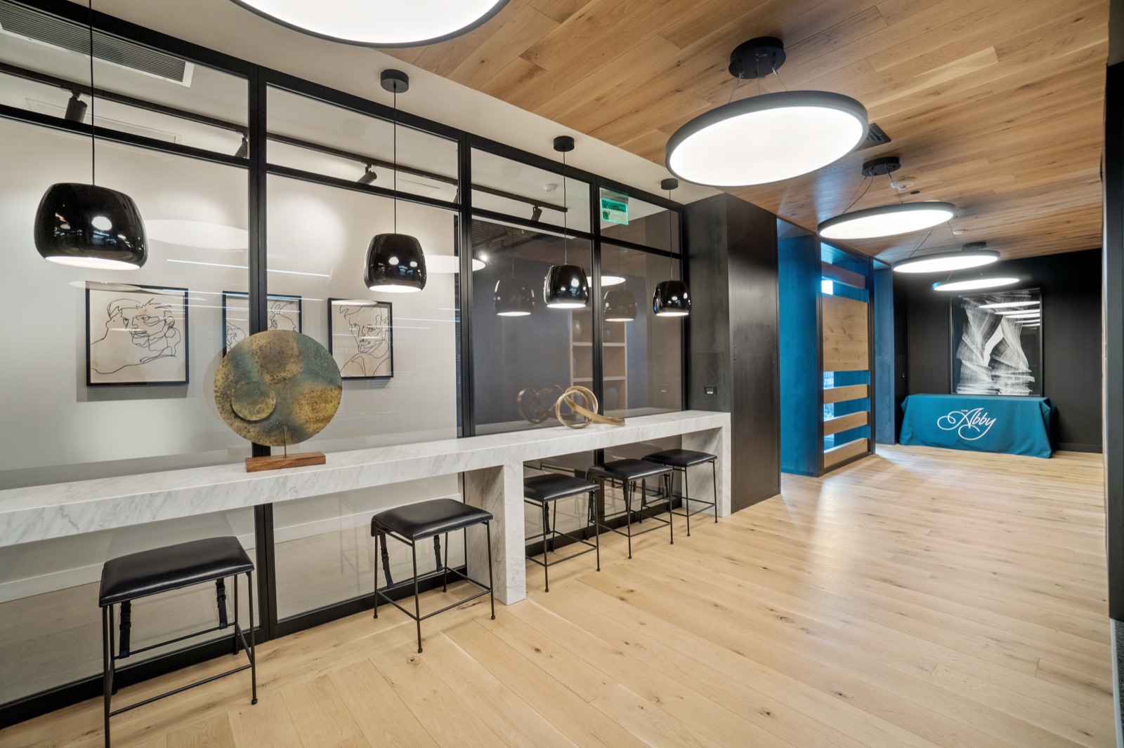 Modern co-working lounge with long table and pendant lights