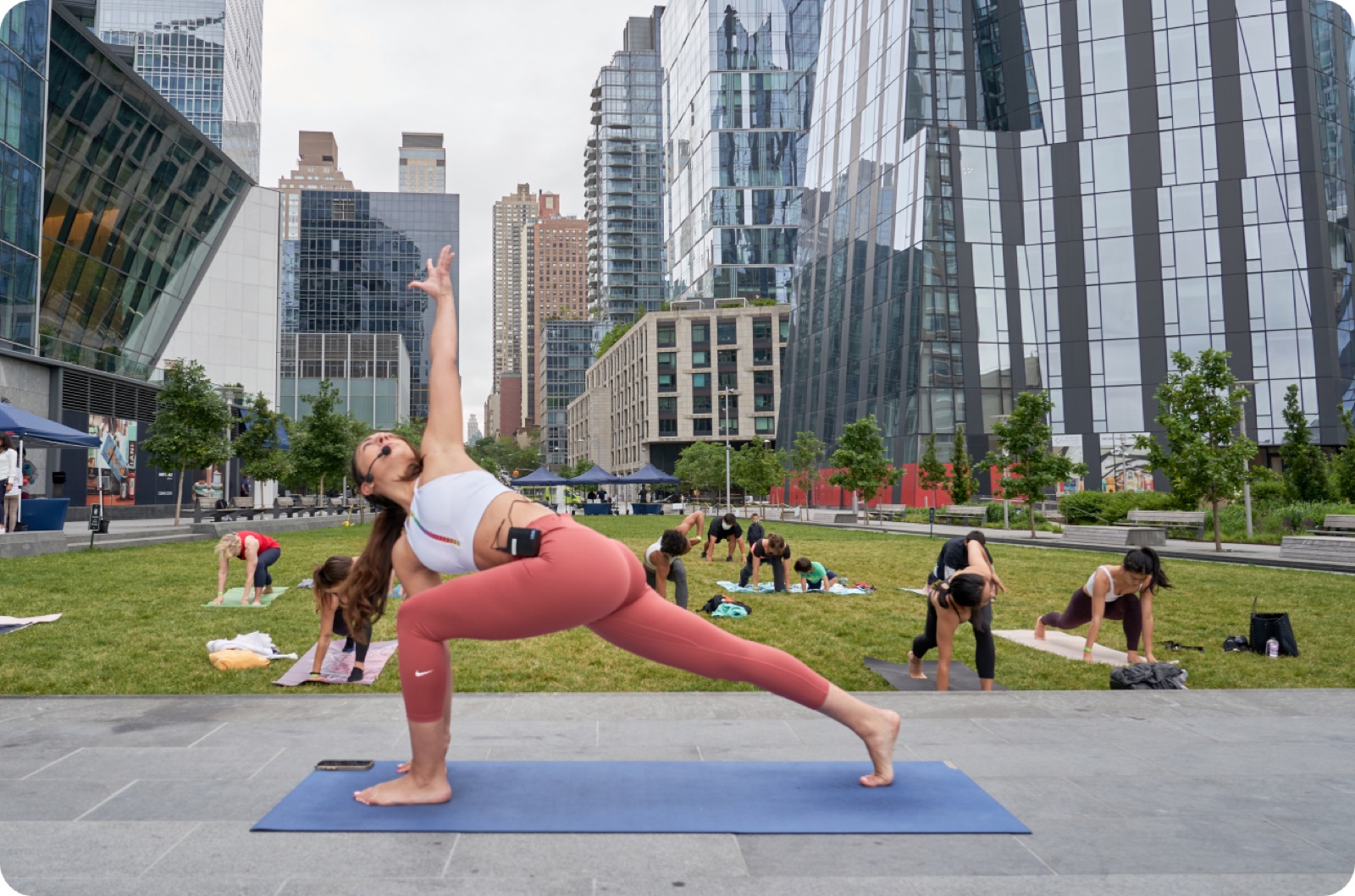 Outdoor group yoga class on an urban plaza
