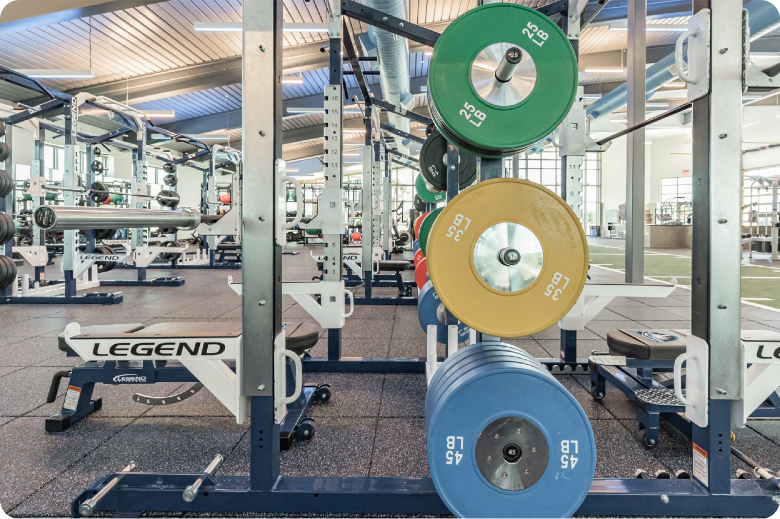 Commercial gym strength equipment with color bumper plates